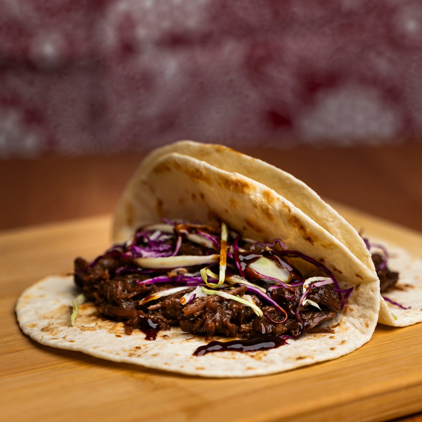 Campers Pantry BBQ Pulled Beef Brisket pouch packaging on a light cream background. The packaging features a deep purple top section with yellow text and a white bottom section with red text, alongside a photo of cooked brisket.