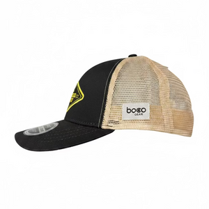 Black and beige technical trucker cap with a new Campers Pantry logo on a textured black surface.